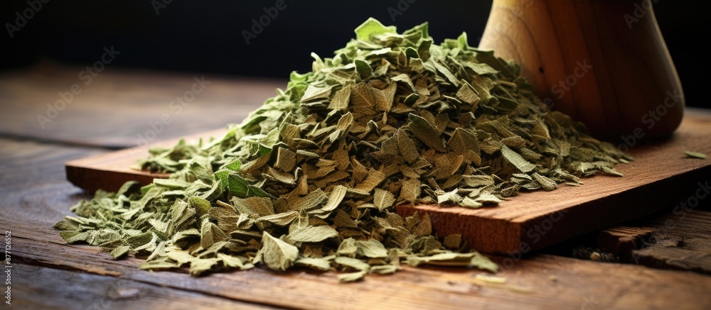 Poster dried basil flakes stack on rustic wood, ideal as a background for a copy space image.