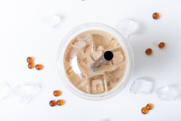 Plastic glass with bubble tea and ice. Trendy summer drink on white background