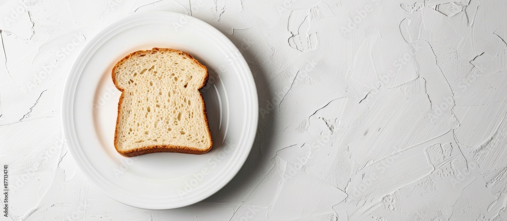 Poster a slice of bread displayed on a white plate, with copy space image.