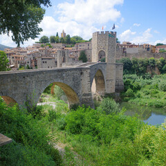 Girona, Spain - 7 July, 2024: The medieval Pont Vell bridge crossing the River Fluvia at Besalu, Catalonia