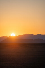 sunrise over the mountains and sand dunes of sossusvlei, namibia