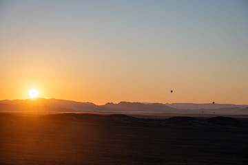 hot air balloons at sunrise in sossusvlei national park, namibia