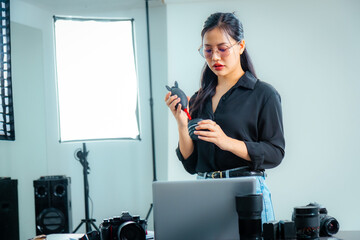 Female photographer cleaning lens before use.