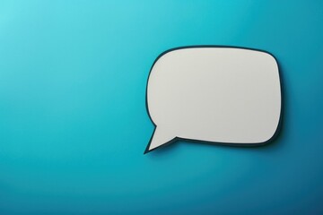 Fototapeta premium A single white speech bubble floating on a bright blue background, perfect for adding text to an image or highlighting a quote