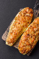 Zucchini halves baked with cheese, tomatoes, meat or meat substitute