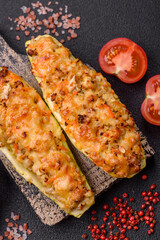 Zucchini halves baked with cheese, tomatoes, meat or meat substitute