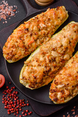 Zucchini halves baked with cheese, tomatoes, meat or meat substitute