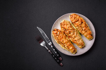 Zucchini halves baked with cheese, tomatoes, meat or meat substitute