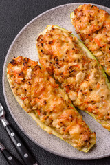 Zucchini halves baked with cheese, tomatoes, meat or meat substitute