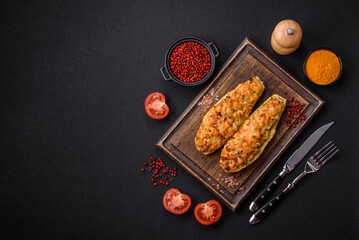 Zucchini halves baked with cheese, tomatoes, meat or meat substitute