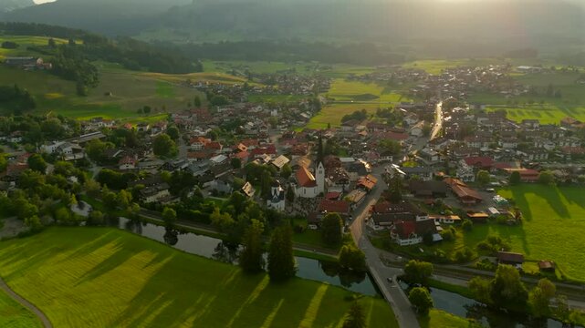 Aerial view of Fischen im Allgau near Oberstdorf at sunset in sunny summer weather in Bavaria, Germany Landkreis Oberallgau. Fischen im Allgaeu Luftaufnahme. Pfarrkirche St. Verena. Frauenkapelle. 