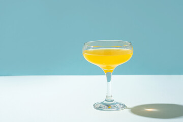 Cocktail spritz yellow color on blue background
