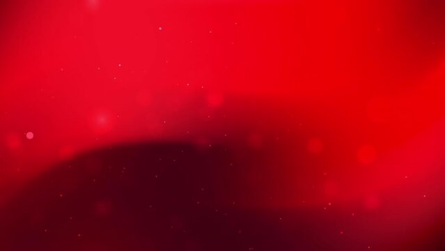 Red gradient background with blurred red dots is suitable for festive designs, Valentines Day, or abstract backgrounds for various digital projects.