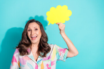 Photo portrait of lovely pensioner lady hold speech bubble dressed stylish colorful garment isolated on cyan color background