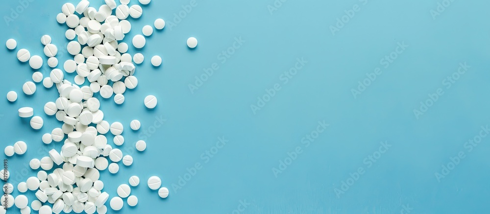 Aufkleber pharmacetic concept featuring a pile of pills on a blue background in a top view copy space image