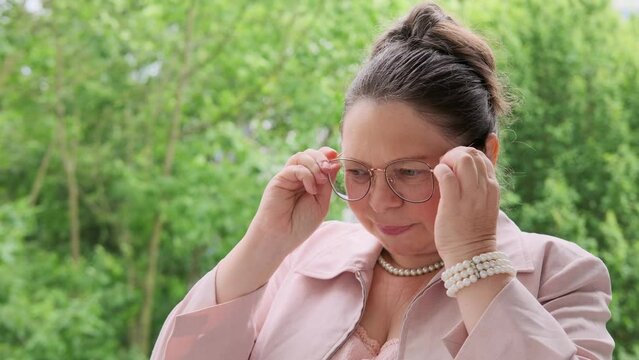 mature lady looks through corrective lenses, headache due to wrong glasses, struggling with visual fatigue, mature eyesight issues, vision wear, corrective eyewear
