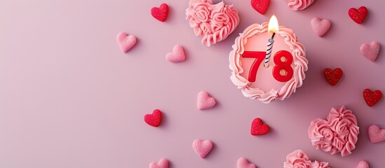 Top view of a pink themed birthday card for a girl with numbers hearts and a candle displaying the number 78 Includes copy space for personalized messages