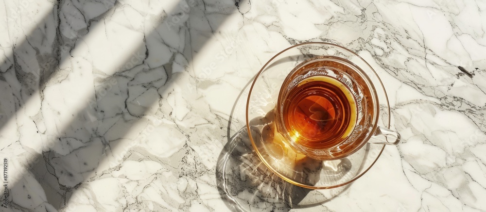 Aufkleber Top view of a transparent glass mug with saucer on a marble surface perfect for showcasing with available copy space image