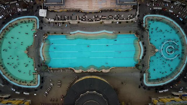 Aerial view. Thermal Bath Szechenyi in Budapest, Hungary.Public Bath. People in Water Pool. Best outdoor bath in the city park. Sauna, thermal water, medical massage, steam bath.