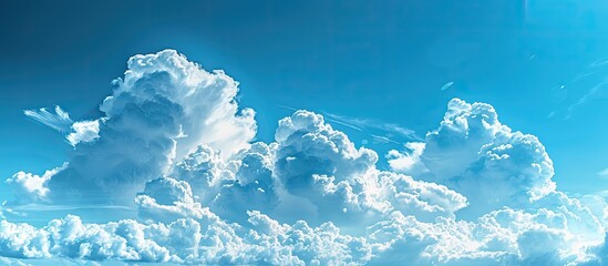 A panoramic view of a vast blue sky with billowing clouds ideal for copy space image