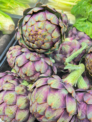 Obraz premium Title: Fresh Organic Purple Artichokes in Market Display