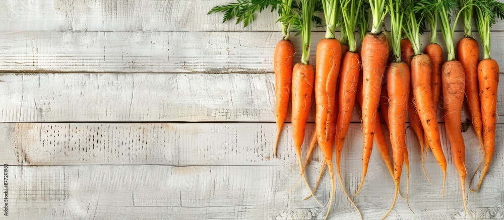 Poster Fresh carrots arranged on a rustic white wood table with a blank space for an image. with copy space image. Place for adding text or design
