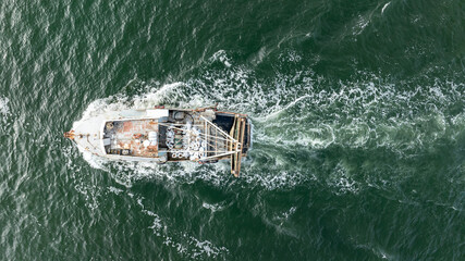 Aerial view of trawler vessel. Fishing boat trauler with sacks full of rapani © dechevm