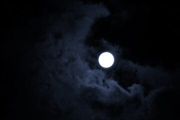 Obraz premium Midnight sky background. Night mysterious landscape in cold tones - full moon in the night sky and dramatic night clouds. 