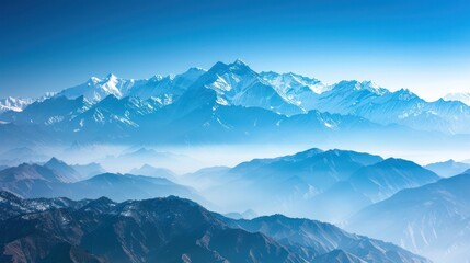 A breathtaking view of the Himalayas from the Indian side, with snow-capped peaks under a clear blue sky, highlighting natural beauty