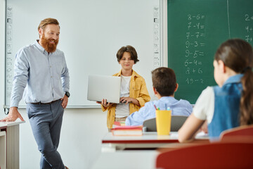 A man teacher standing confidently in front of a diverse group of kids, actively instructing them...
