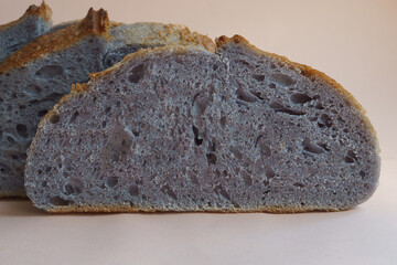 close-up Freshly baked homemade Unusual and creative blue artisan sourdough bread. Sliced.