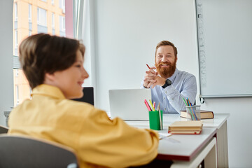 A man sits attentively at a desk, engaged in conversation with a child.