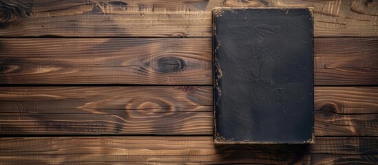 Fototapeta premium Vintage book displayed on a wooden surface with copy space image