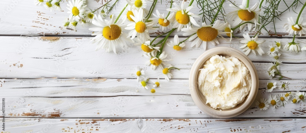 Aufkleber white wooden background with shea butter and chamomile ideal for a copy space image