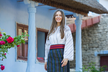 Beautiful girl in traditional Romanian folk costume with embroidery. Woman traditional blouse. Romanian folklore