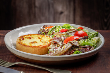 Quiche with lettuce and tomato salad. Healthy food.