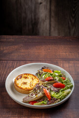 Quiche with lettuce and tomato salad. Healthy food.