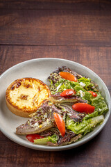 Quiche with lettuce and tomato salad. Healthy food.