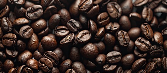 Naklejka premium Detailed view of coffee beans roasted with copy space image