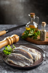 Raw sardine fish seasoned with garlic ready to cook.