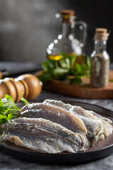 Raw sardine fish seasoned with garlic ready to cook.