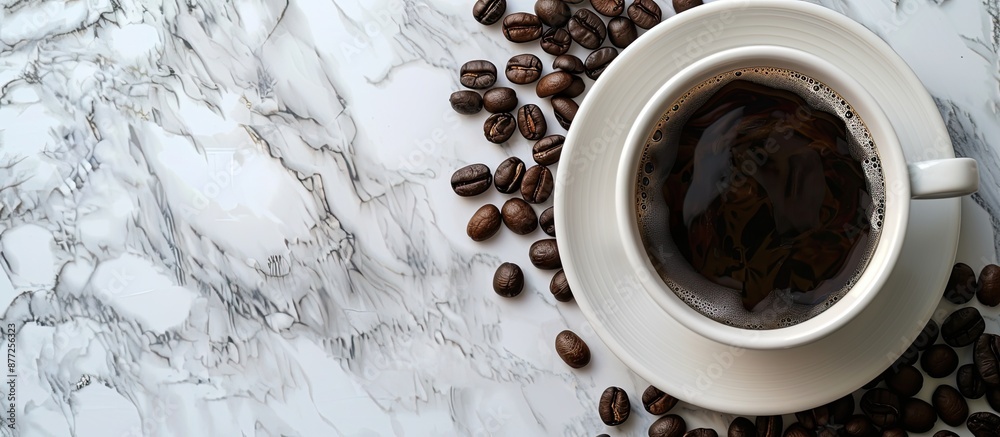 Fototapete a cup of black coffee and coffee beans displayed on a marble table suggesting a breakfast or nightti