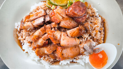 Crispy pork rice on a white plate on the dining table