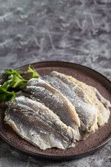 Raw sardine fish seasoned with garlic ready to cook.