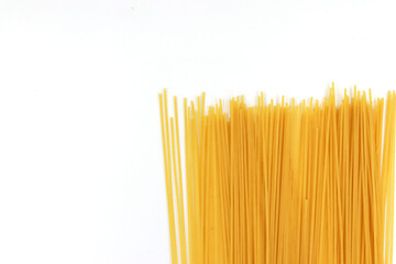 Yellow long spaghetti on White background. Thin pasta arranged in rows. Yellow italian pasta. Long...