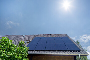 Fototapeta premium Solar Panels on Roof Under Bright Sun