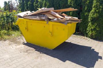 Yellow Dumpster Filled with Construction Debris