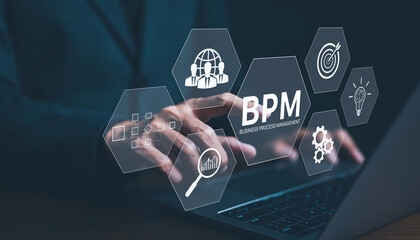 BPM, Business Process Management Concept. A businessman works on a laptop with virtual icons representing business process management, various elements of business strategy, efficiency, and workflow.