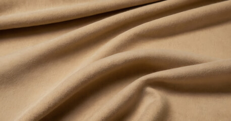 Obraz premium Luxurious beige cashmere fabric draped on a white background. Ideal for fashion, textile, or luxury product promotions.
