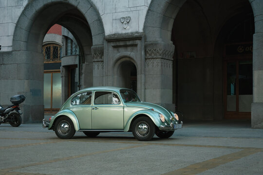 1960s Volkswagen Beetle in turquoise pearl green metallic color is driving in Subotica, Serbia, 29.06.2024